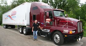 Millis driver standing near truck